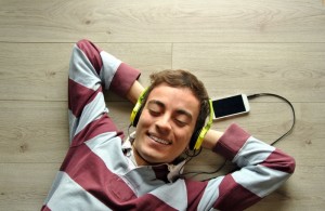 Young man listening to music with mobil